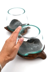 Decorative glass on carved wooden hand